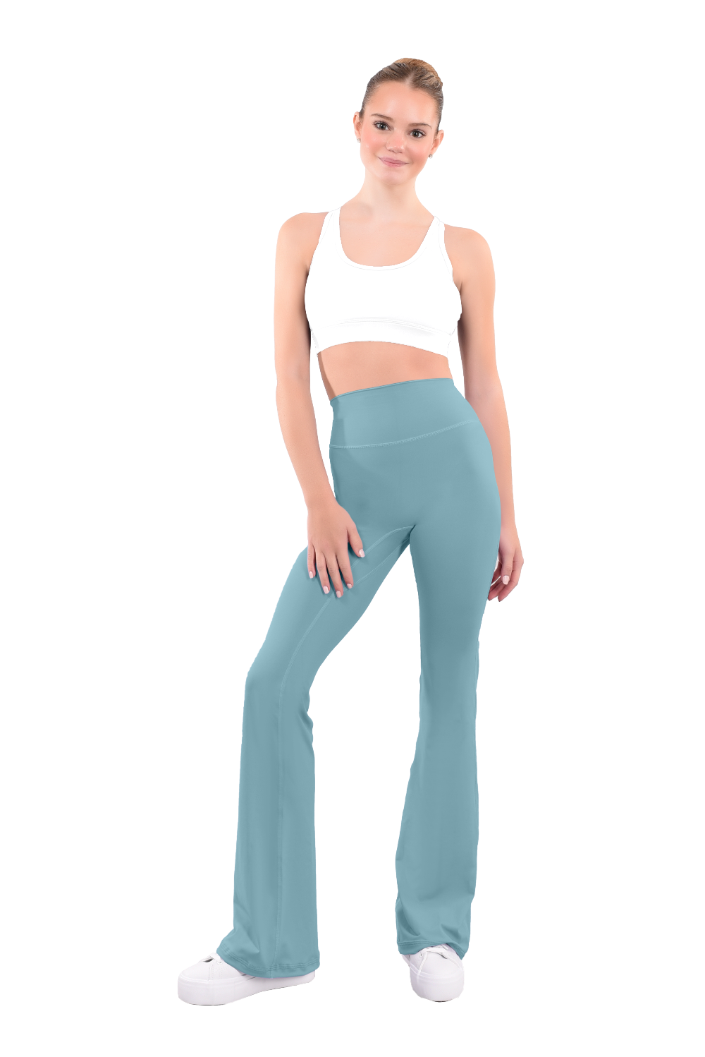 dancer in white sports bra and avocado green high rise flared stretch fit pants