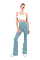 dancer in white sports bra and avocado green high rise flared stretch fit pants