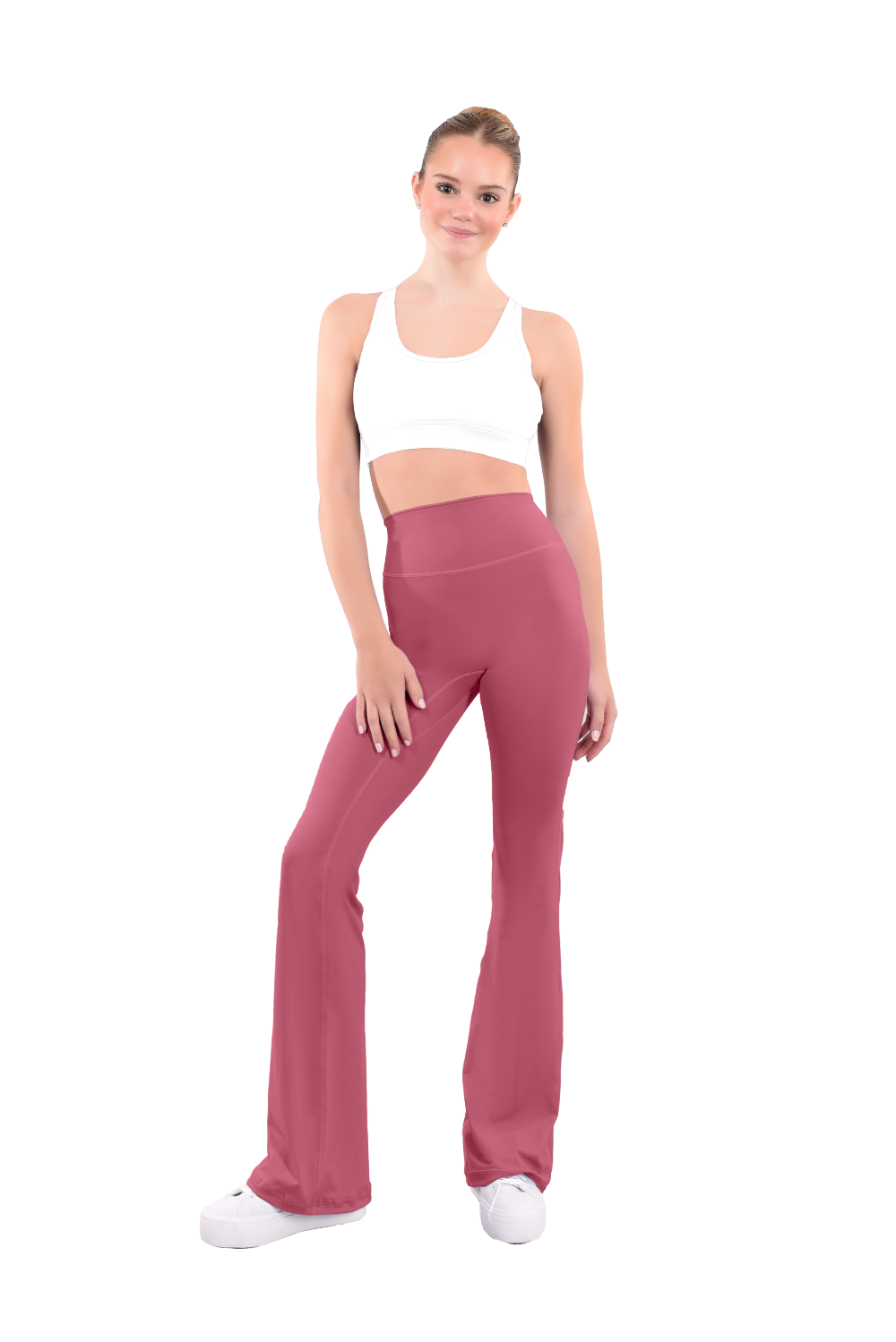 dancer in white sports bra and copper high rise flared stretch fit pants