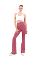 dancer in white sports bra and copper high rise flared stretch fit pants